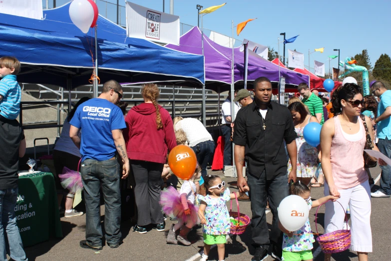 two people and a child are walking in front of the people