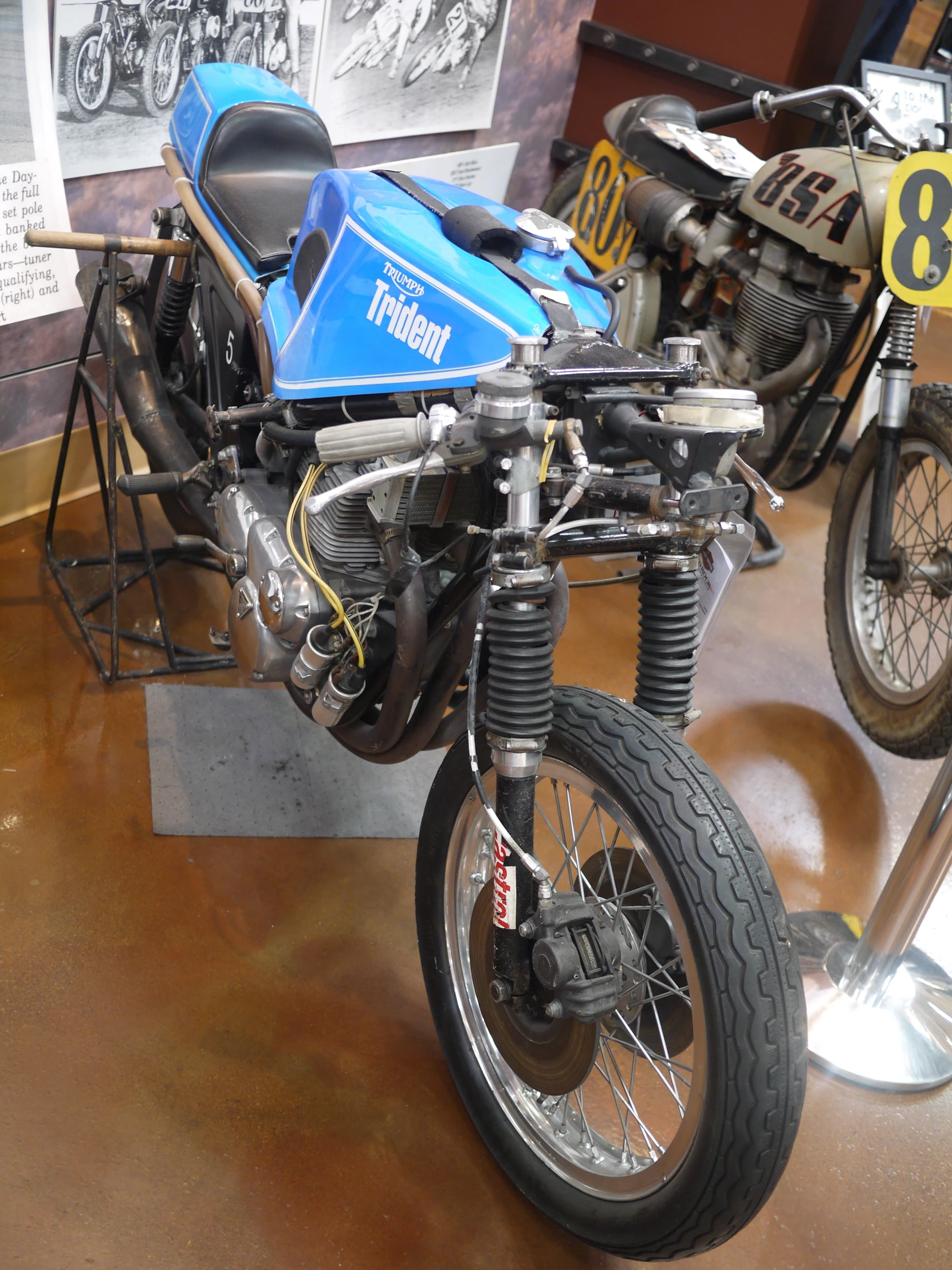 a parked blue motorcycle sitting inside of a room