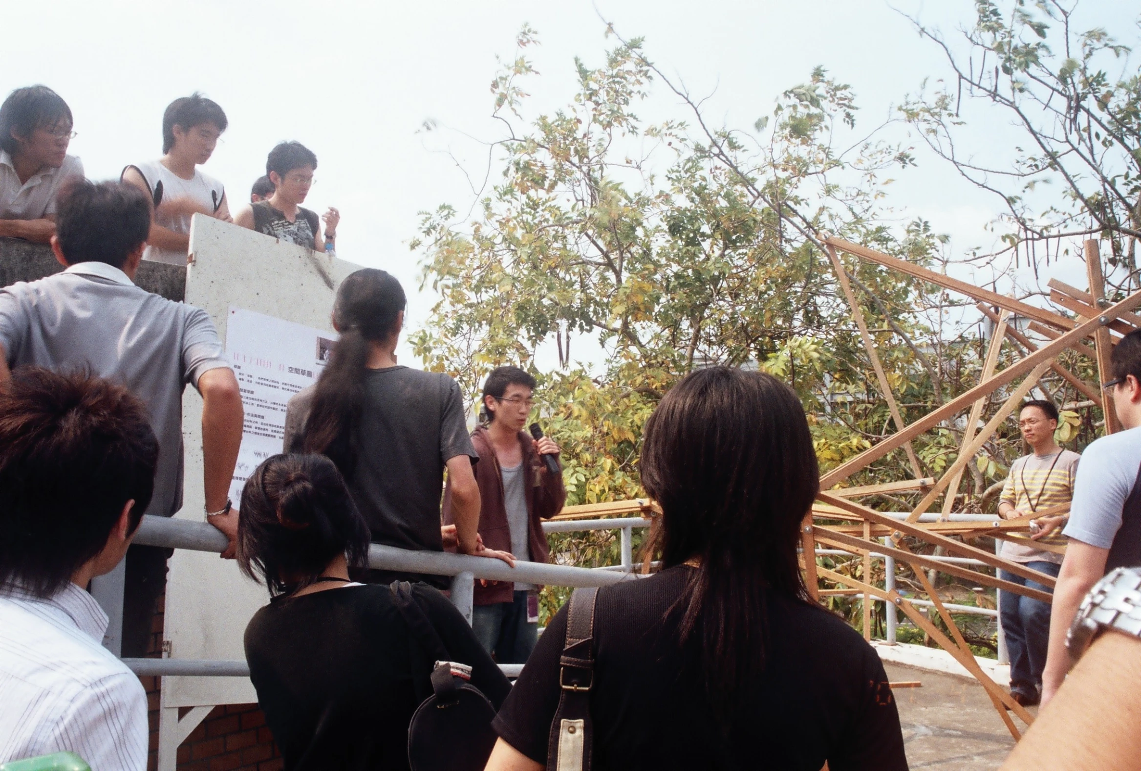 group of people standing at the top of a bridge