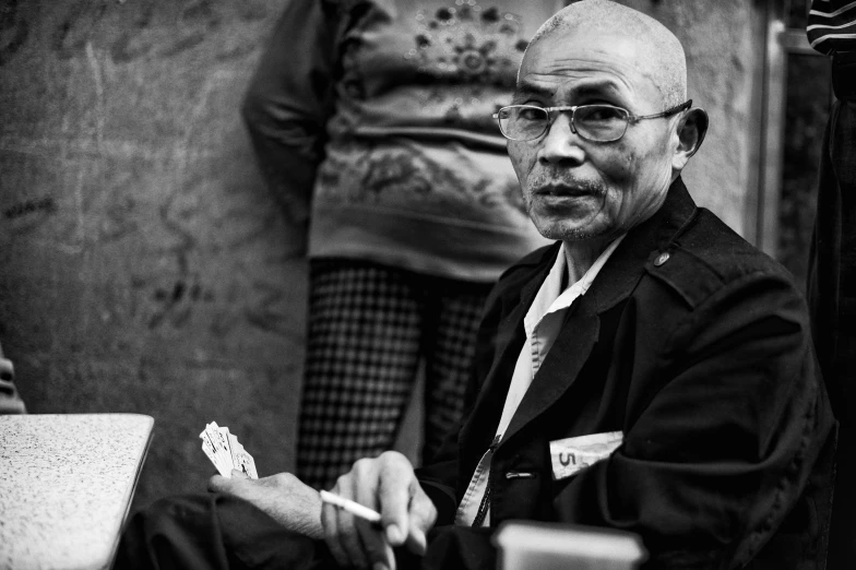 a black and white po of a man sitting at a table