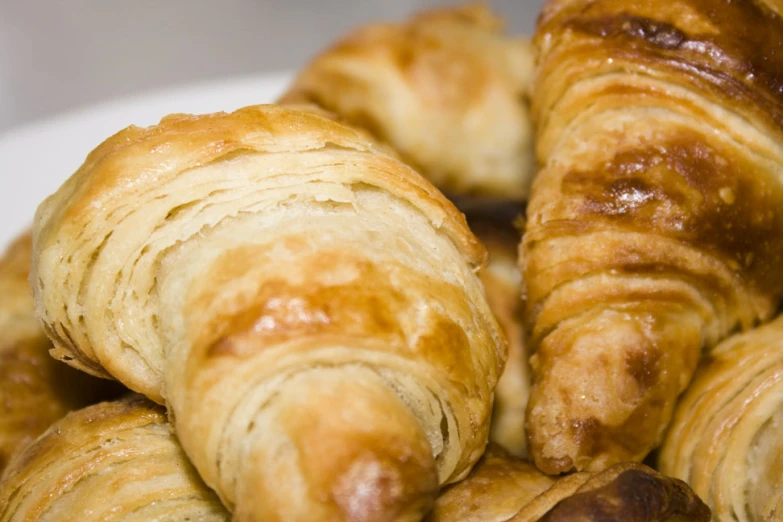 a pile of croissants are piled high on a plate