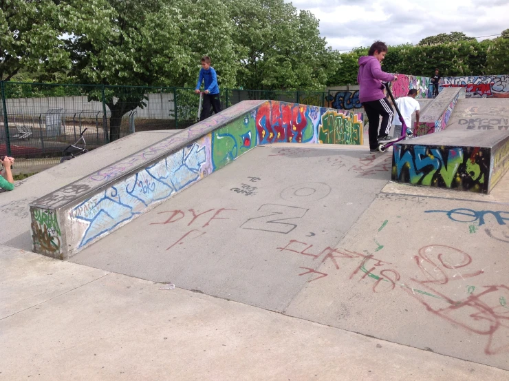 a woman riding on the side of a skateboard ramp