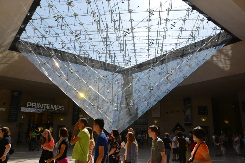 many people are walking around in front of a building