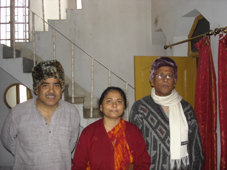 four people standing in front of stairs and looking in