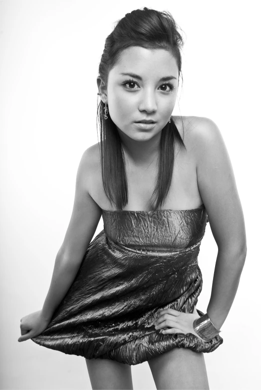 young asian woman with long id in black dress posing for picture
