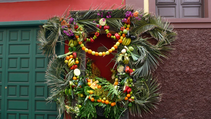 a close up of a wreath with flowers and other decorations