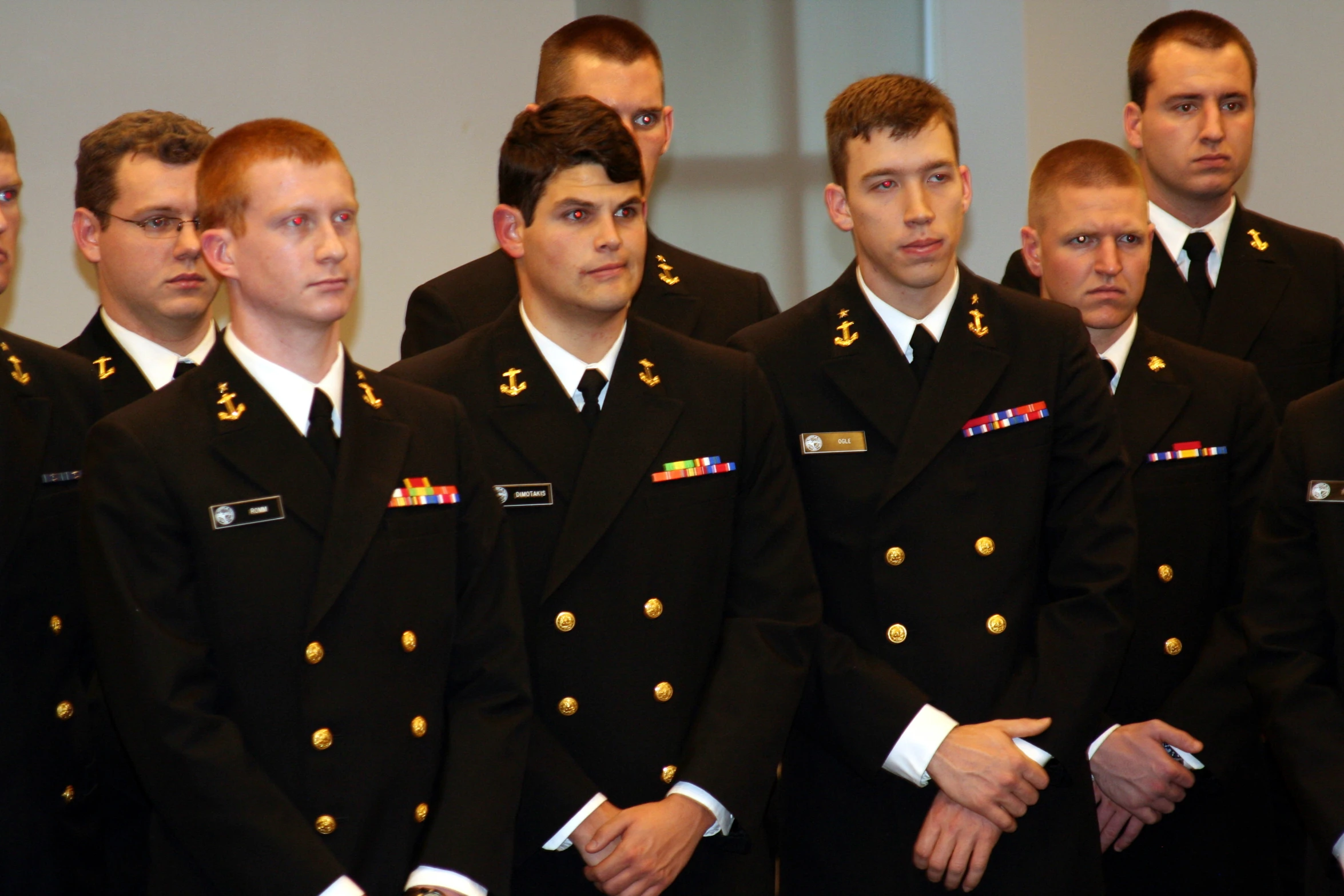 many members in uniform stand for a group po