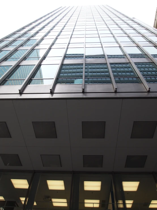 a high rise building with an upward view of the sky