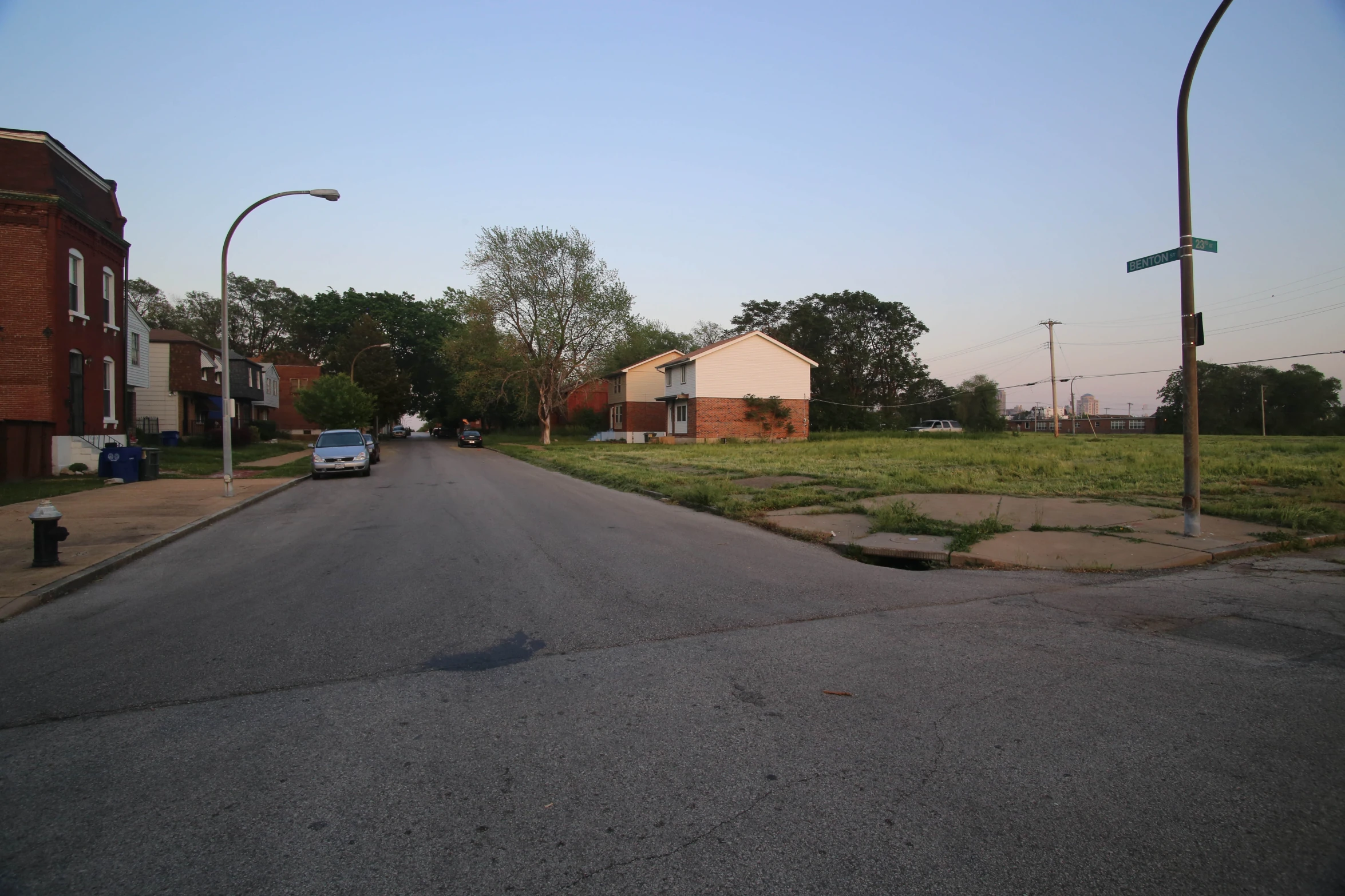 a small town with two cars parked on the street