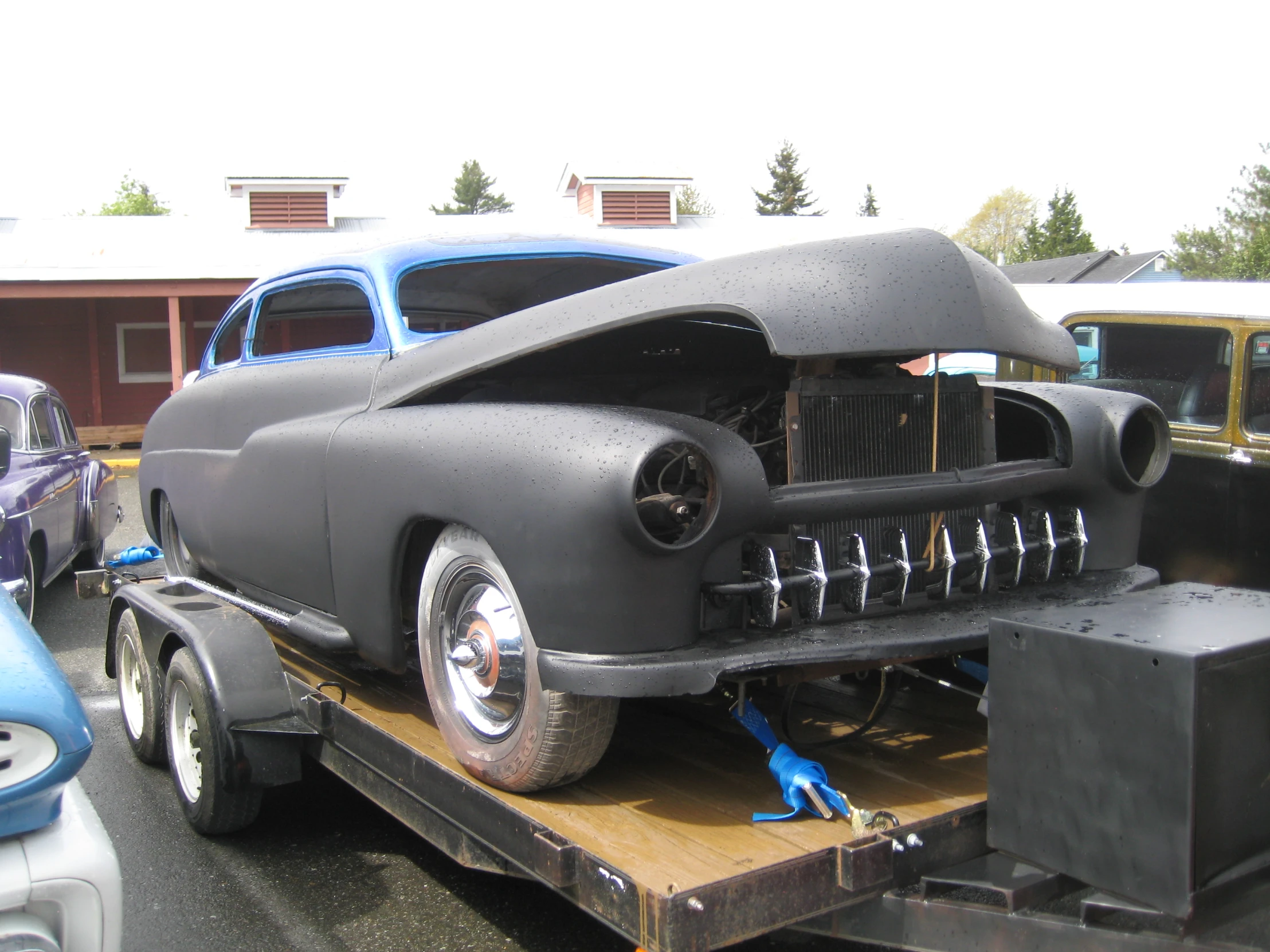 a vintage car being transported to the show