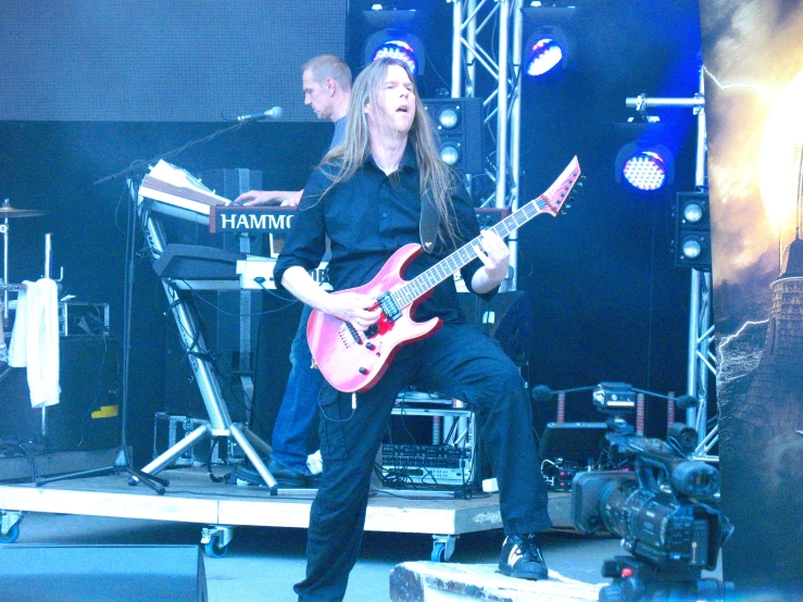a person is playing a guitar on stage