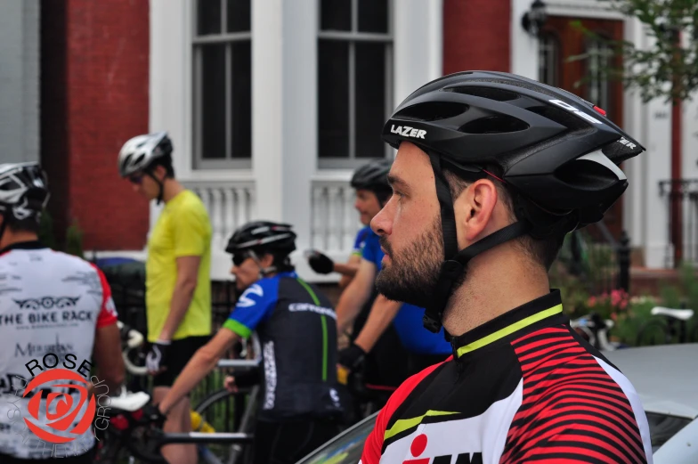 people riding bicycles and motorbikes outside of a building