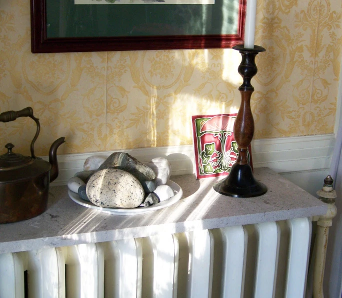 a radiator with dishes and teapot, framed over