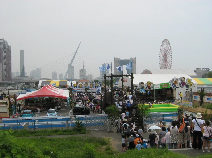 many people are gathering around at a carnival