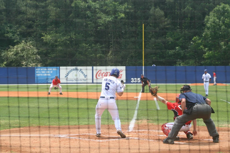 a baseball player is swinging his bat during a game