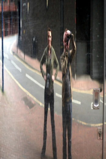 two people standing in front of a mirror