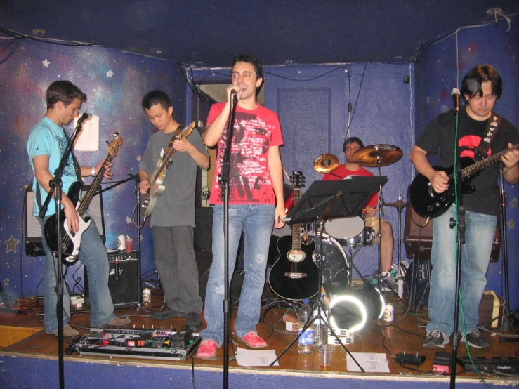 a group of guys singing and playing instruments