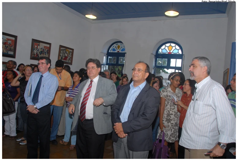 people standing and listening to one another in the hall