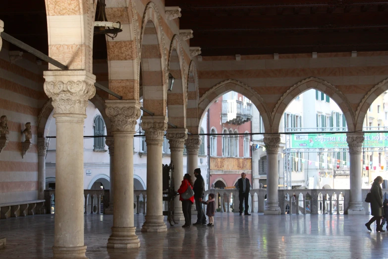 there are several people walking through a building