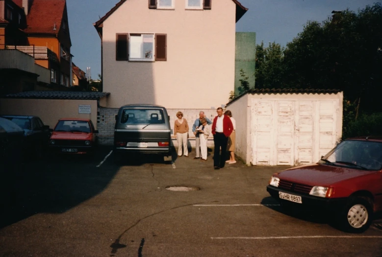 the group is looking at each other next to a building