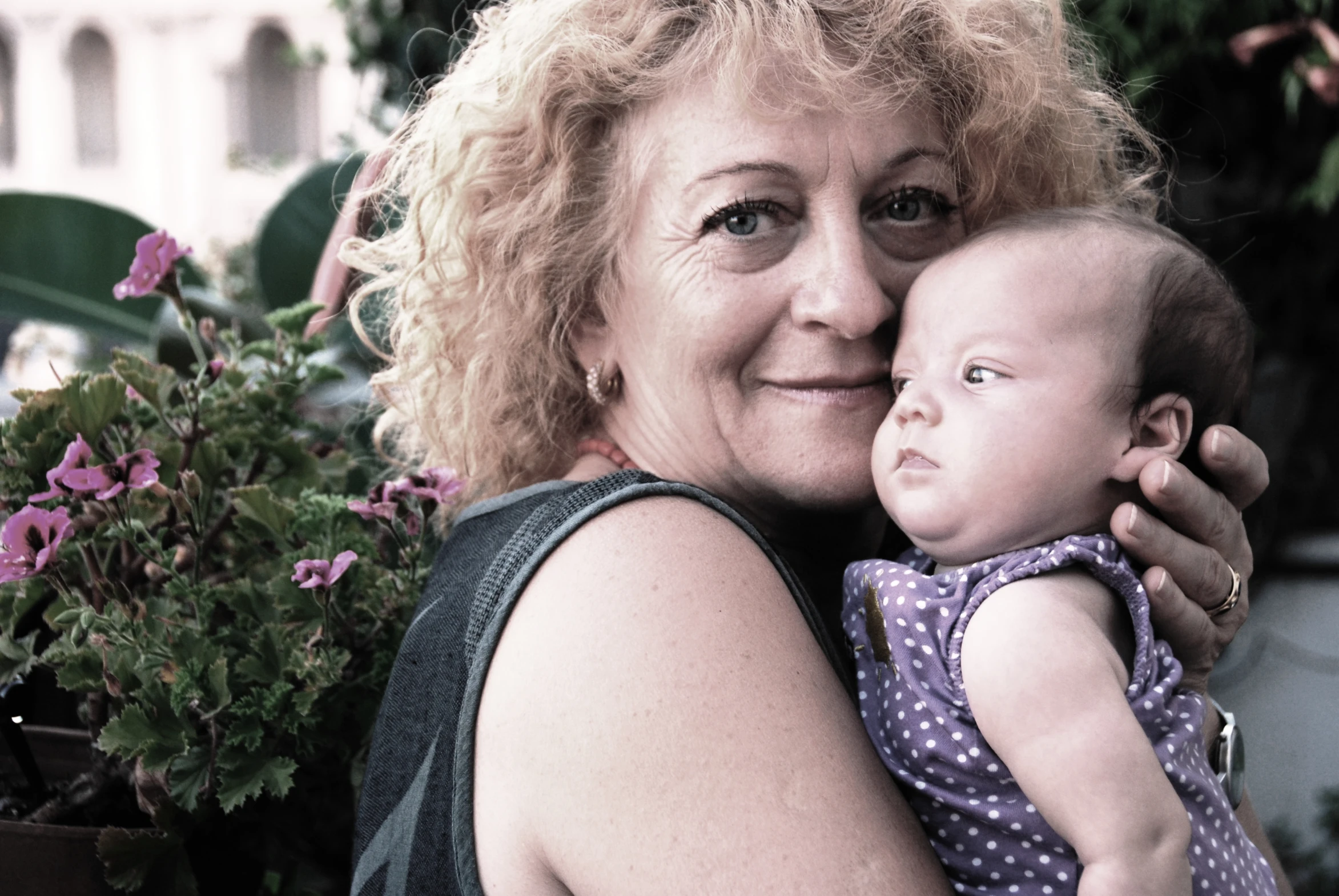 a woman is holding a baby in her arms