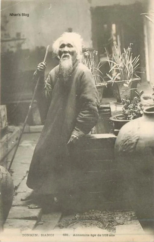 a man sitting down with his cane in one hand and looking at the other