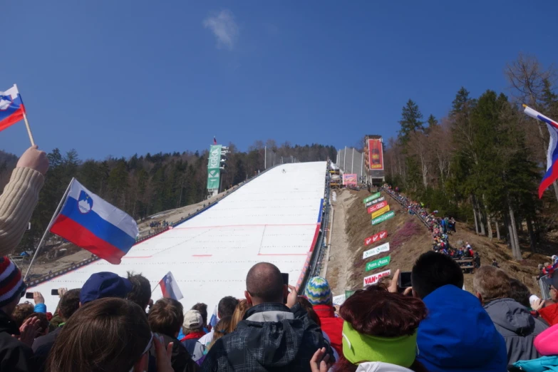 a large crowd is looking at the slope