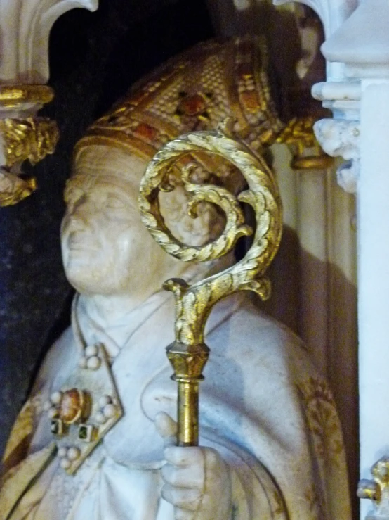 a statue of the god saint with gold decoration