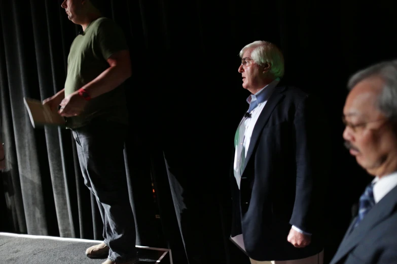 two men stand with one another at a podium