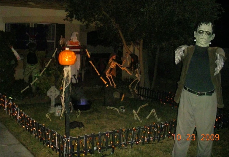 people in halloween costumes near an outcropping fence