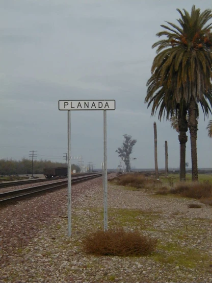 an image of the sign next to the railroad tracks