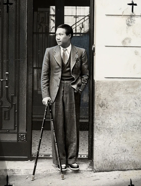 an old black and white po of a man standing in front of a door