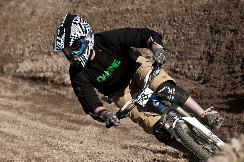 a man on a bike that is racing in dirt