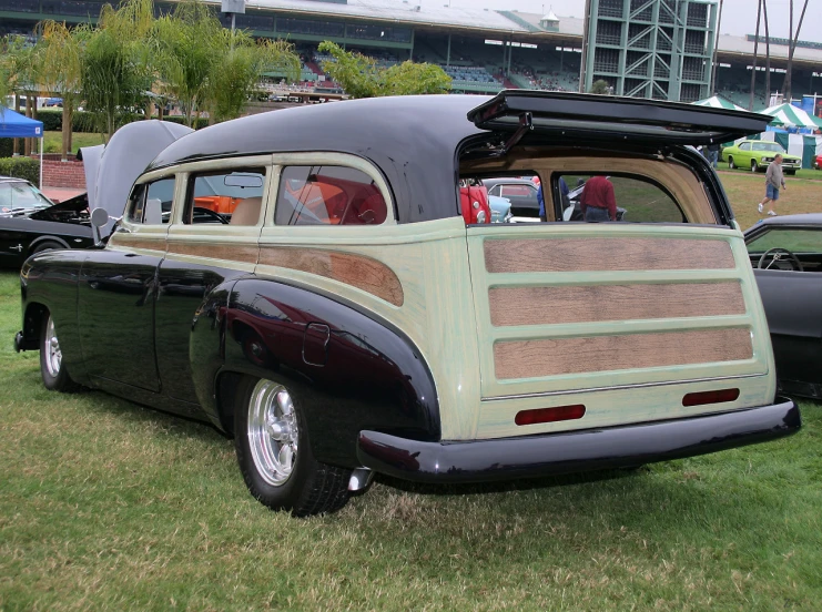 an older style, pickup truck is parked in the grass