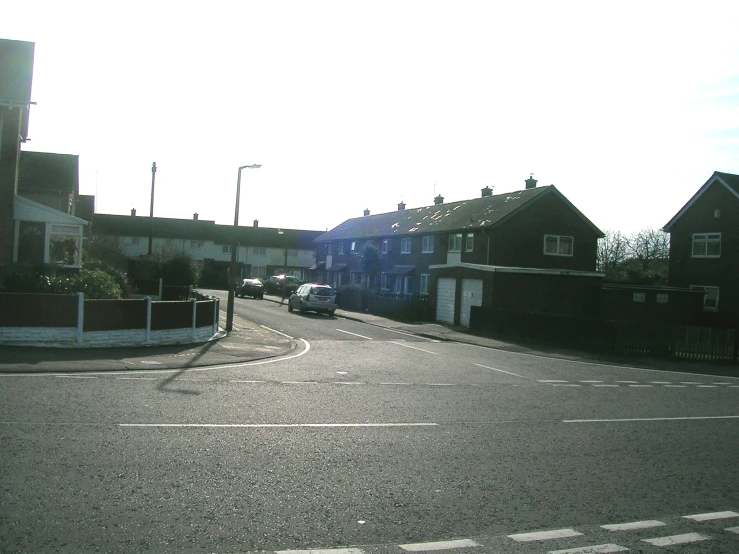 a car driving down a street next to brick buildings