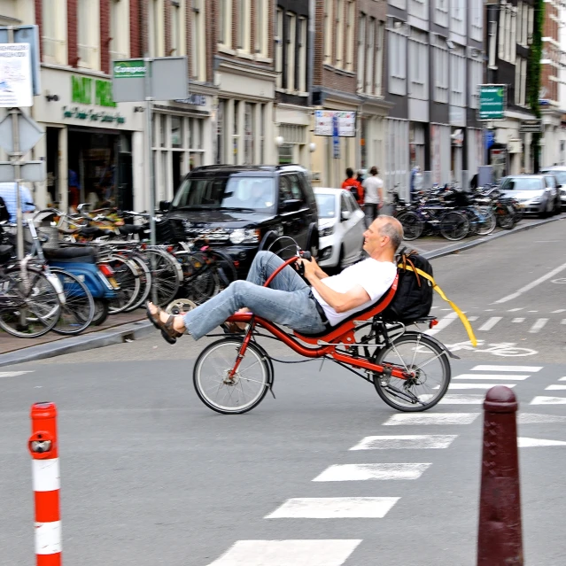 the old man is riding his bicycle while holding a cell phone