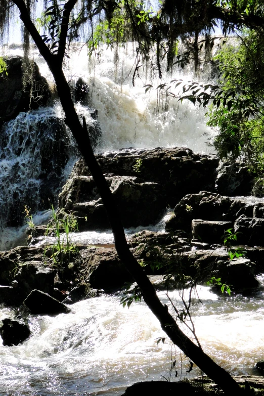 water flowing over rocks and rock walls into a river