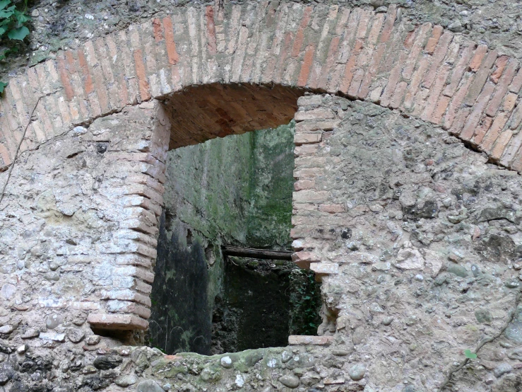 a stone tunnel with an opening in the middle