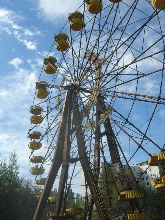 an old ferris wheel with yellow lights on it