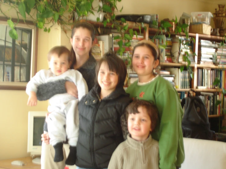 a family posing for a po in front of a tree