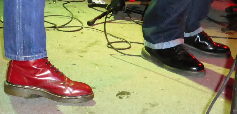 a pair of red shoes sitting on top of a stage