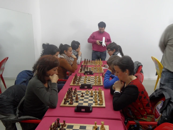 people play chess in an auditorium during a break in action