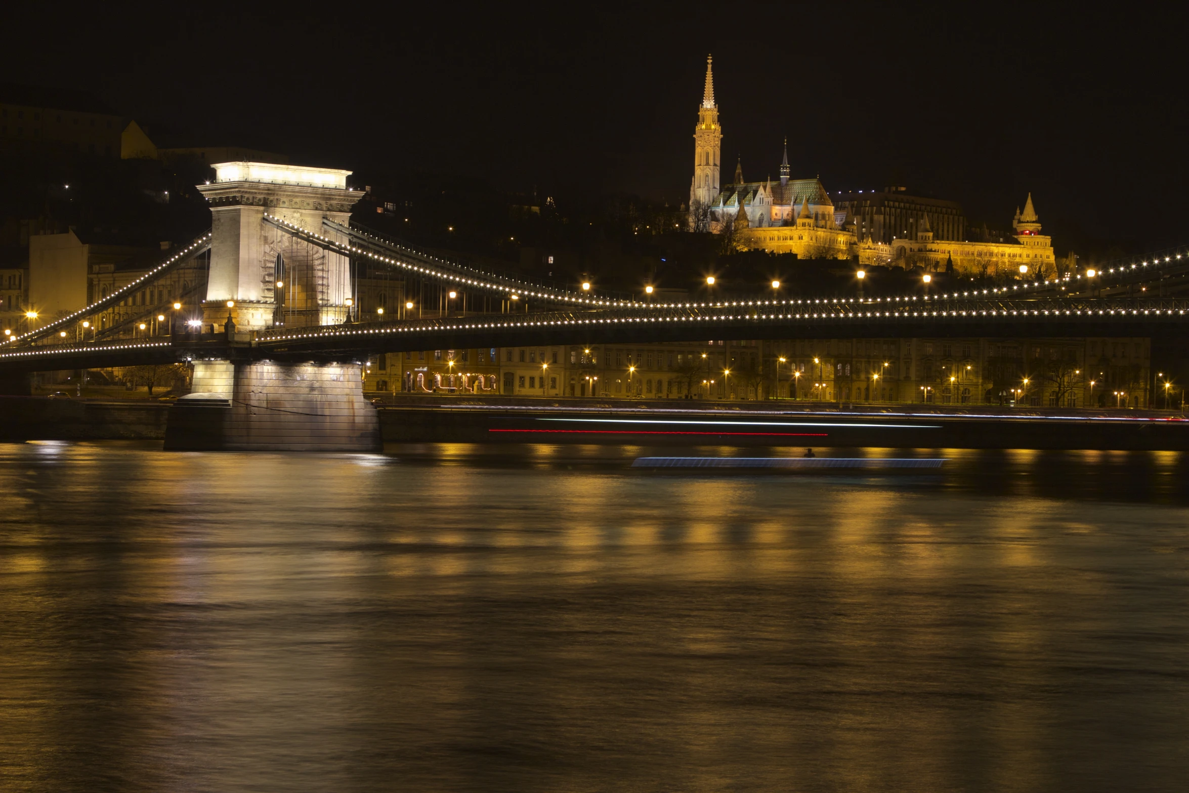 view of the chain bridge from across the water at night