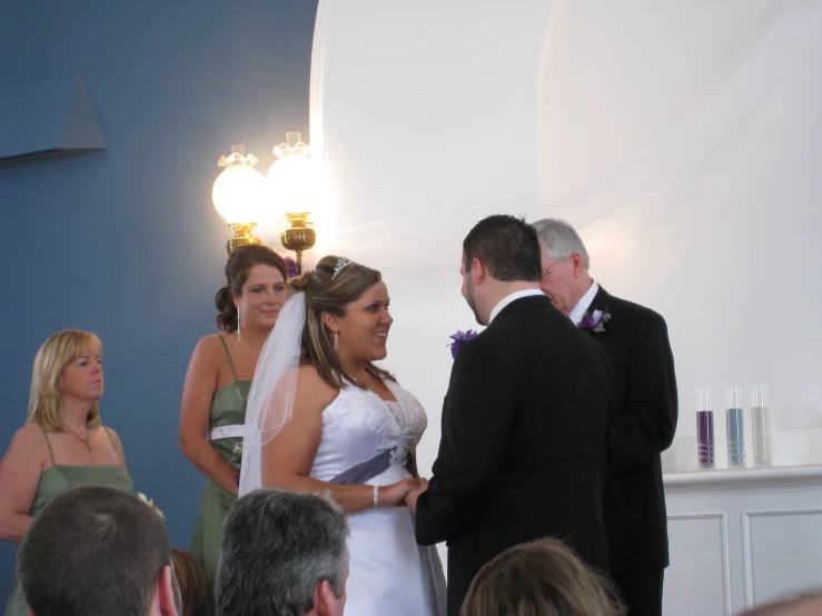 a bride and groom exchanging vows at their wedding
