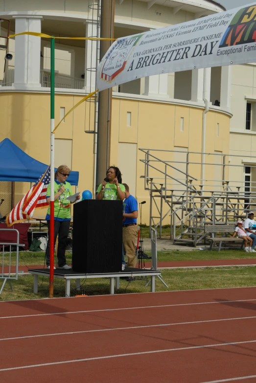 two people standing on top of a race track