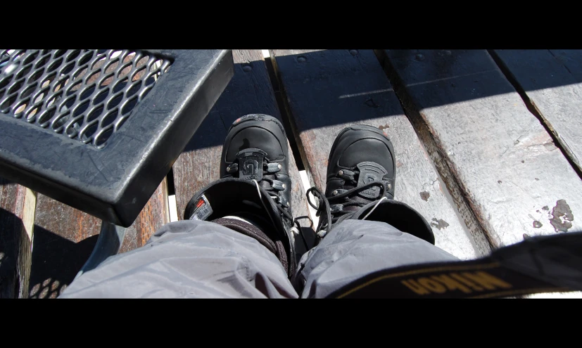 someone's shoes on an outdoor wooden platform