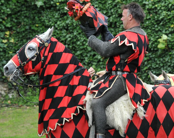 the man is dressed as a knight on a horse