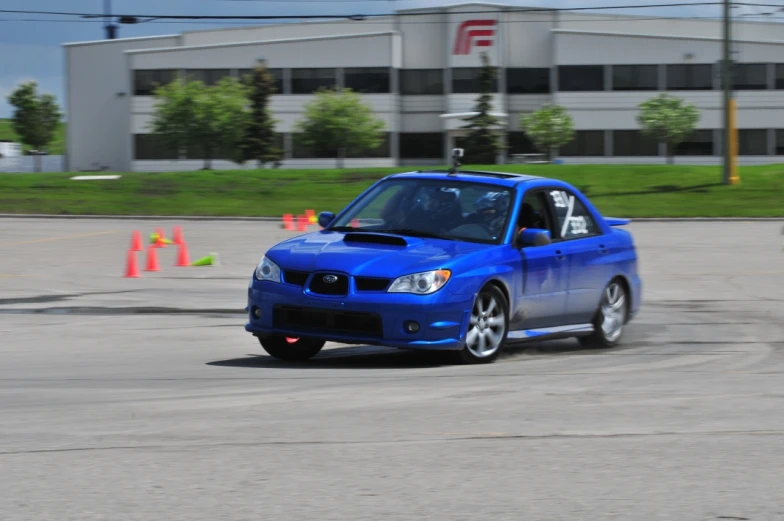 a blue subarunt driving around a corner