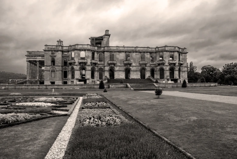 an old mansion with two people walking on the front lawn