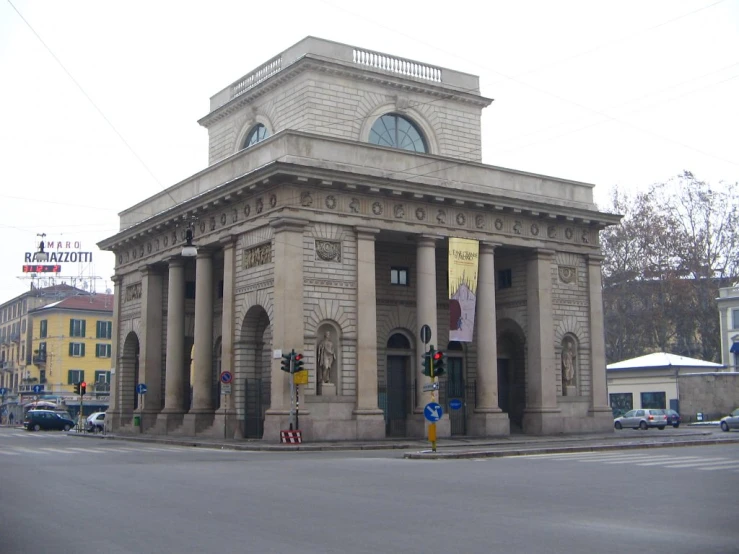 an old building with pillars on a city street